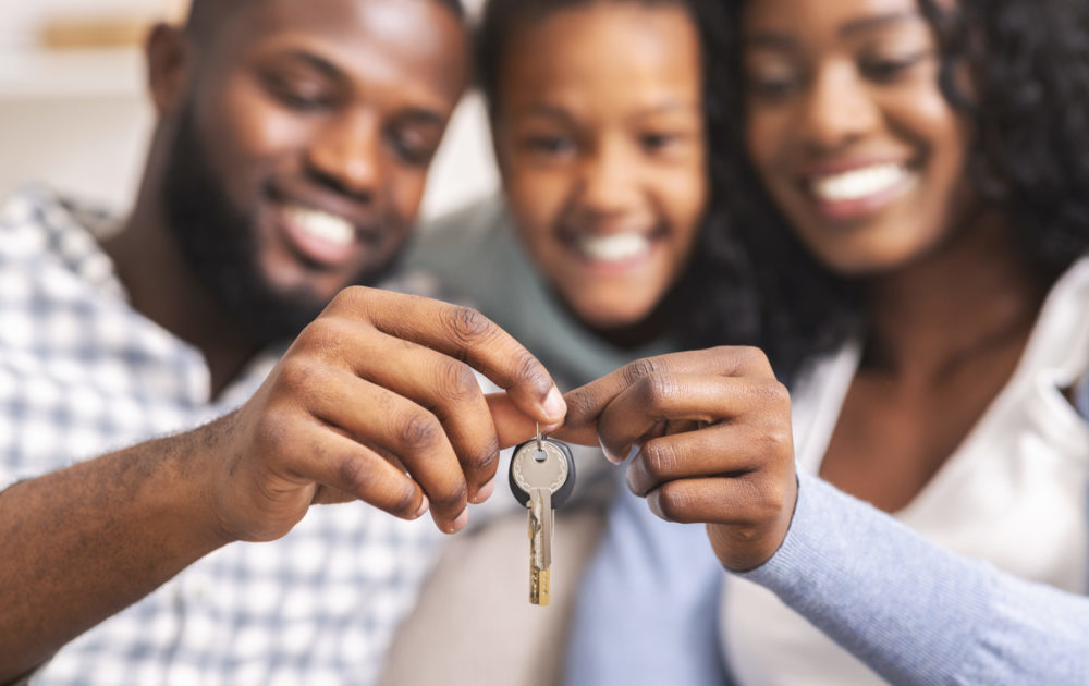 Happy family holding keys from their new home